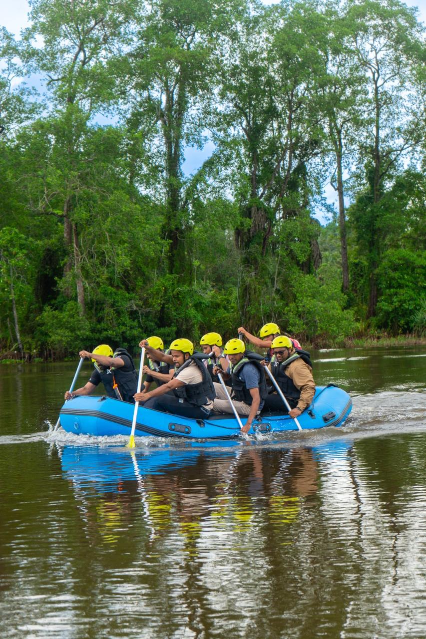 Rafting team paddling the estate river