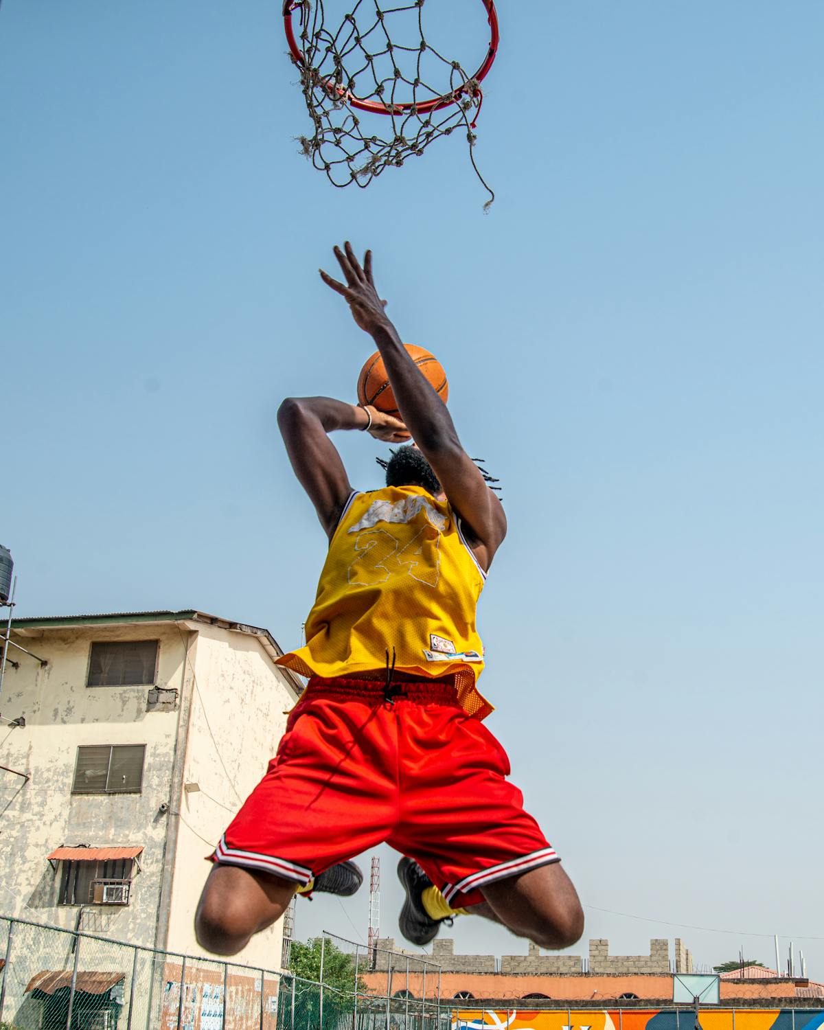 African basketball player mid-air dunk