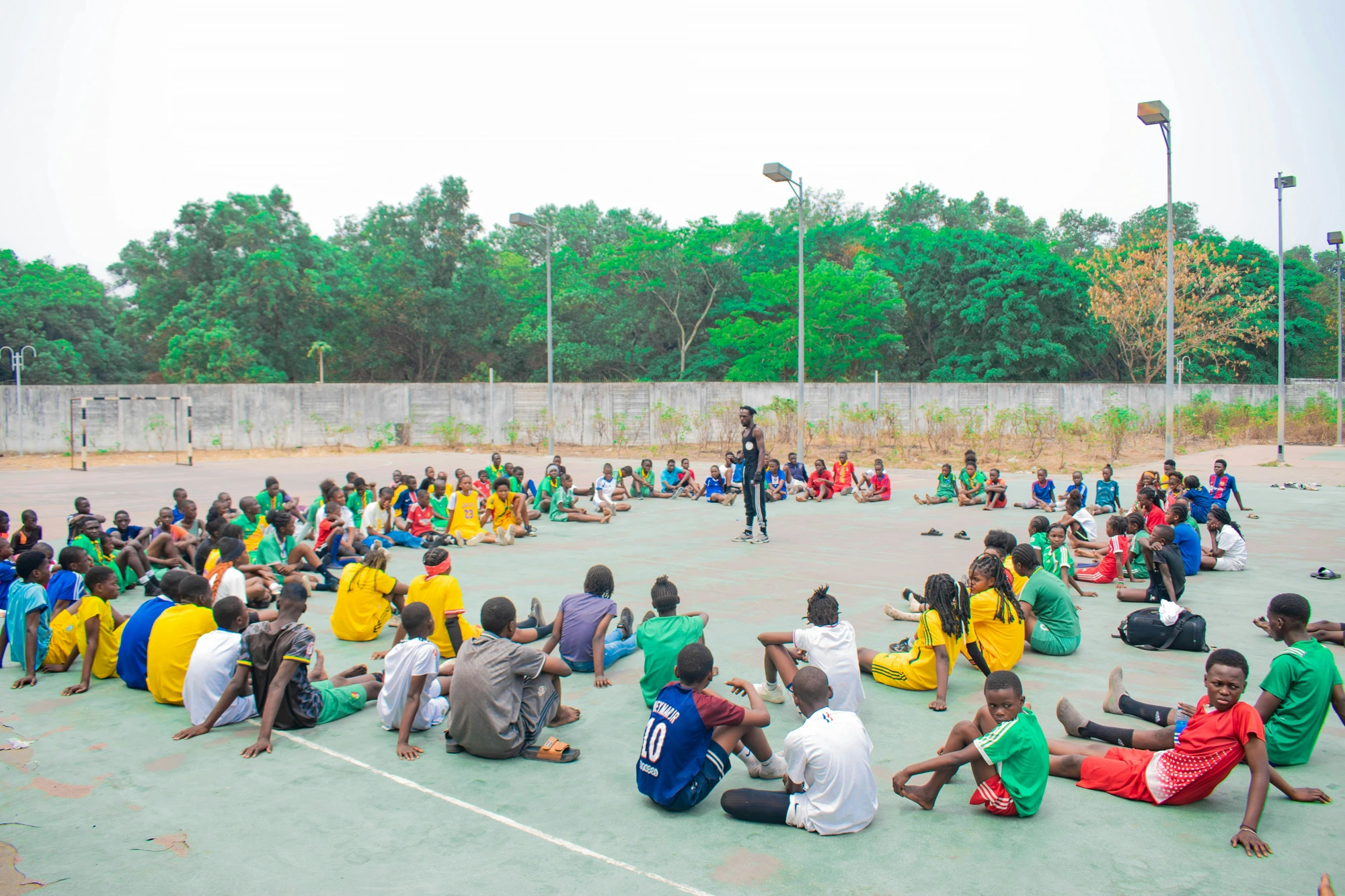 Group of young African athletes gathered on the court