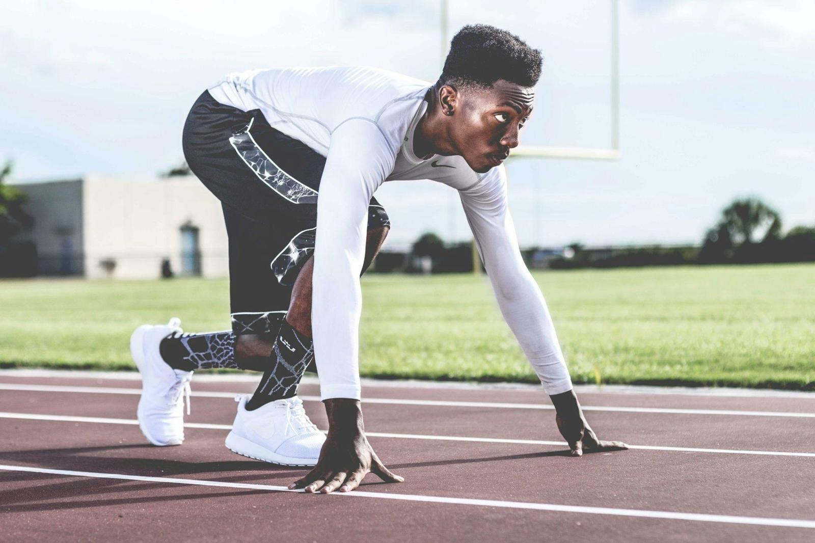 Athlete in starting blocks on running track