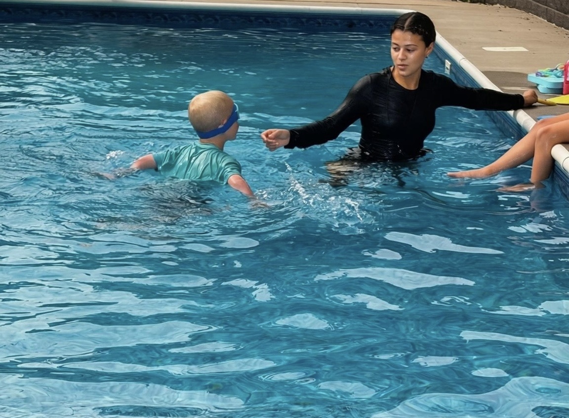 Coach and two swimmers — teamwork in motion