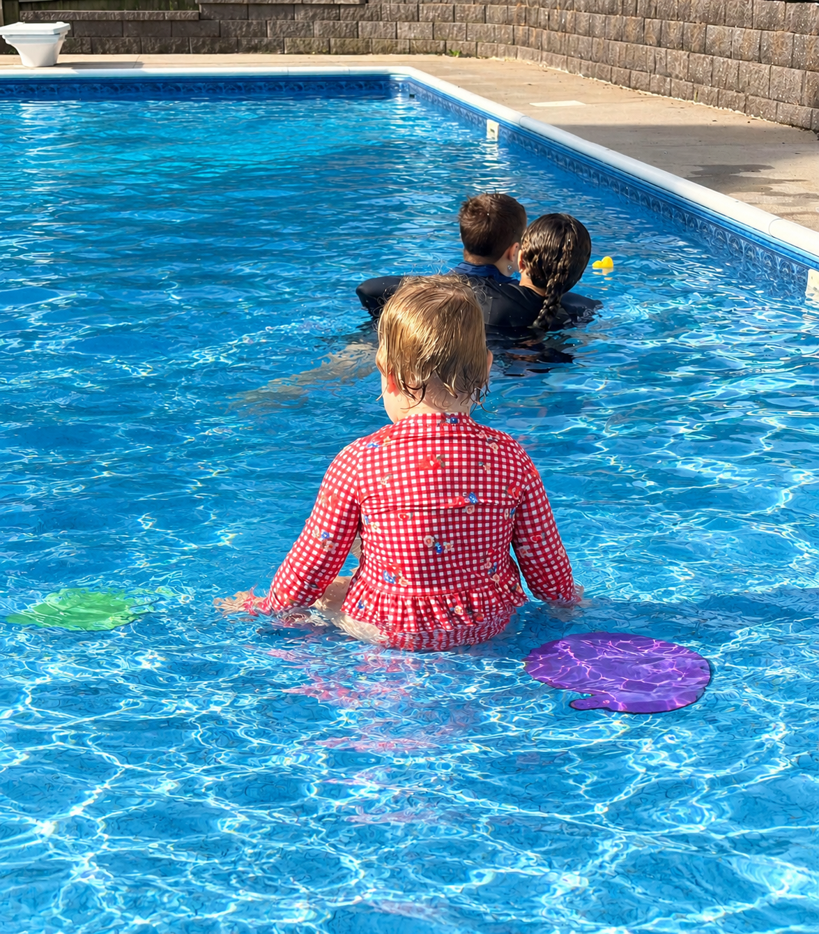 Instructor teaching a child to back float