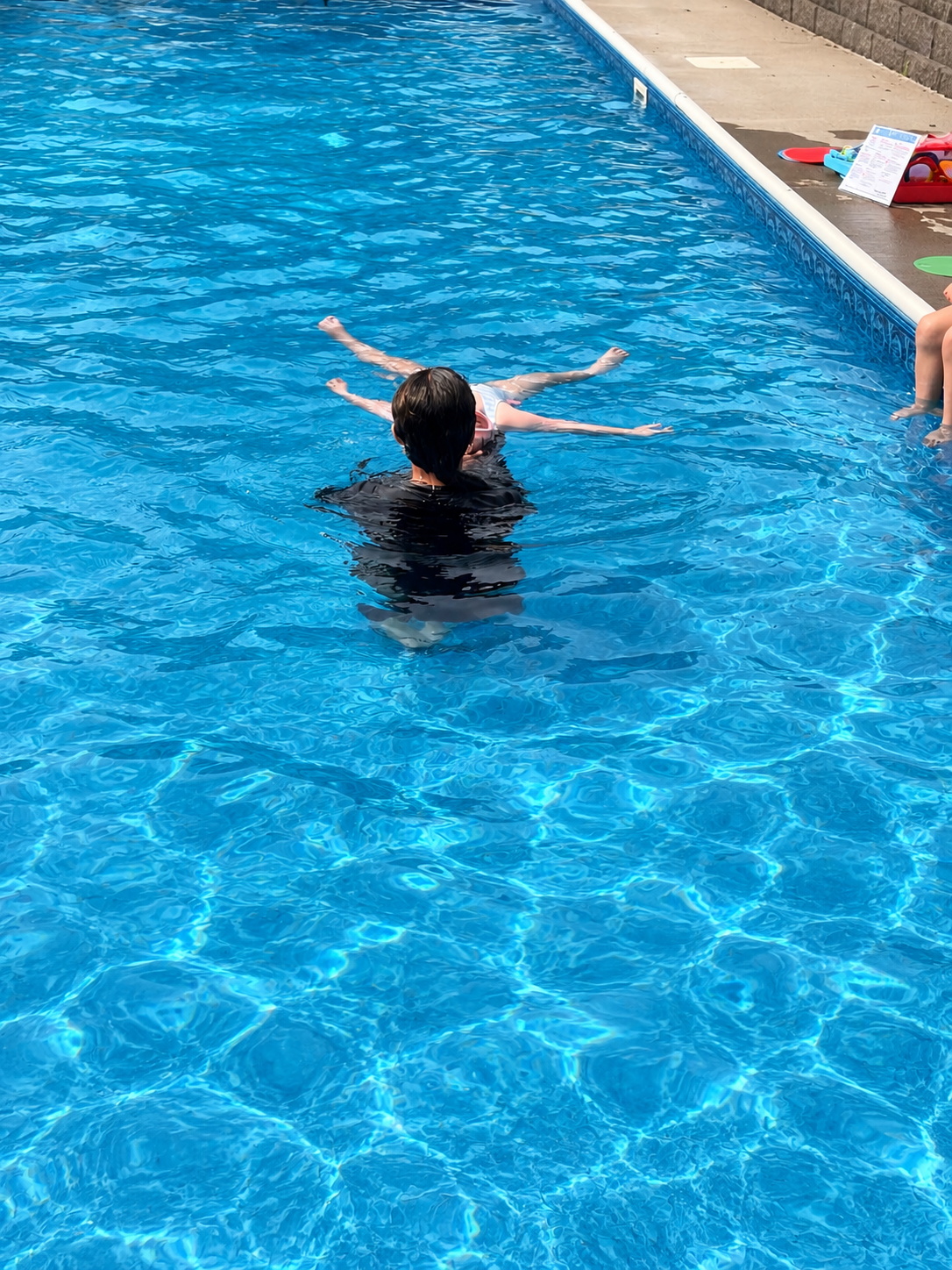First independent back float — arms out, calm and proud