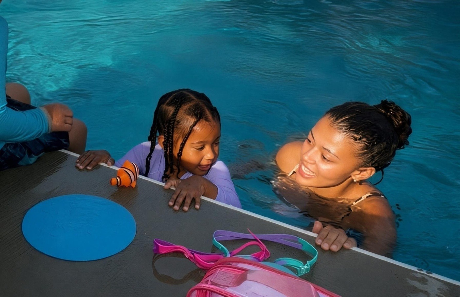 Instructor teaching a child to back float