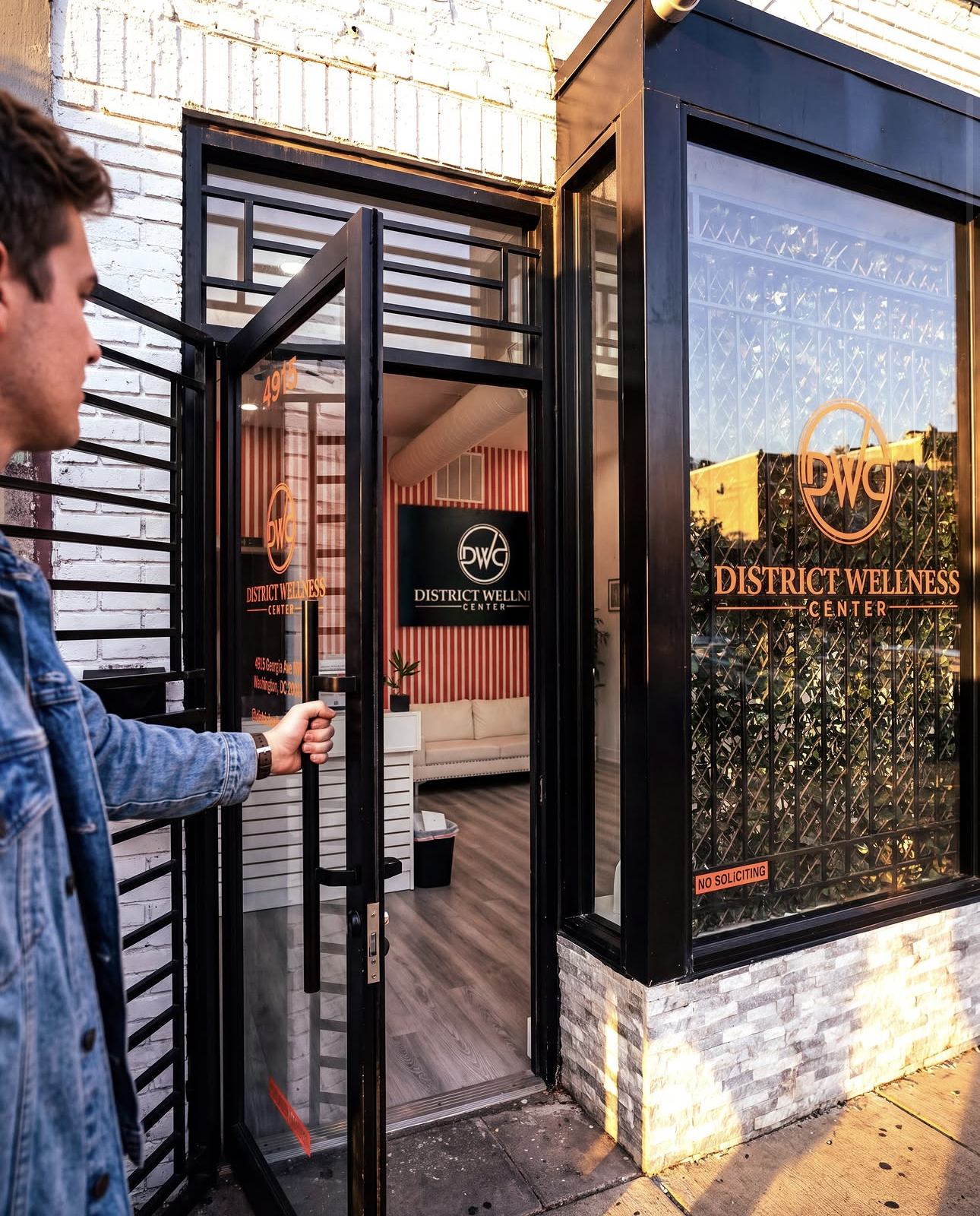 Customer opening the front door of District Wellness Center at 4915 Georgia Ave NW, Washington DC