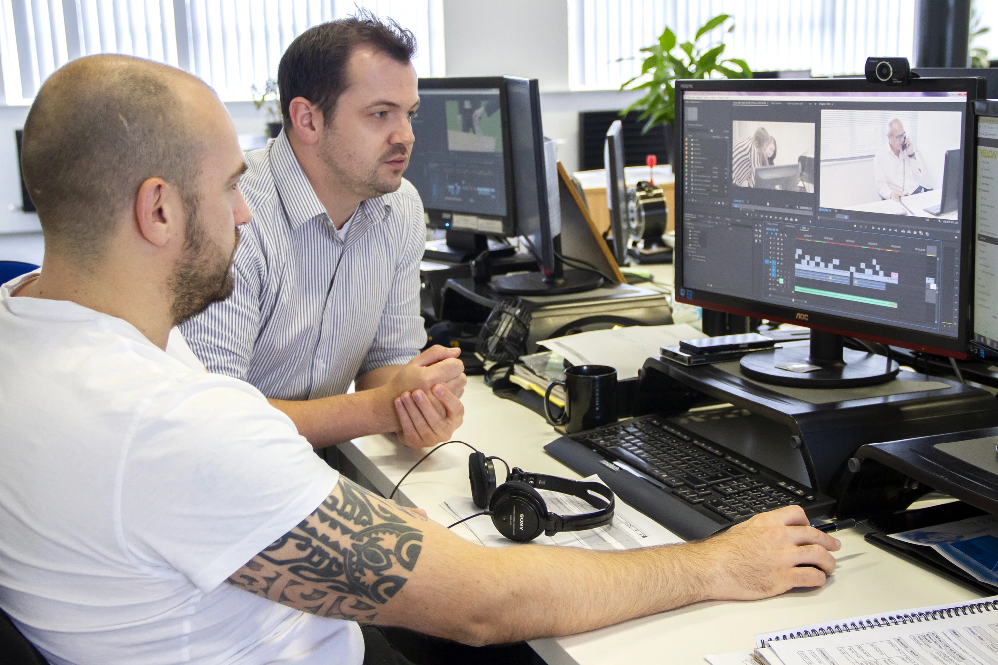 Editors reviewing client footage in Premiere at Yellow