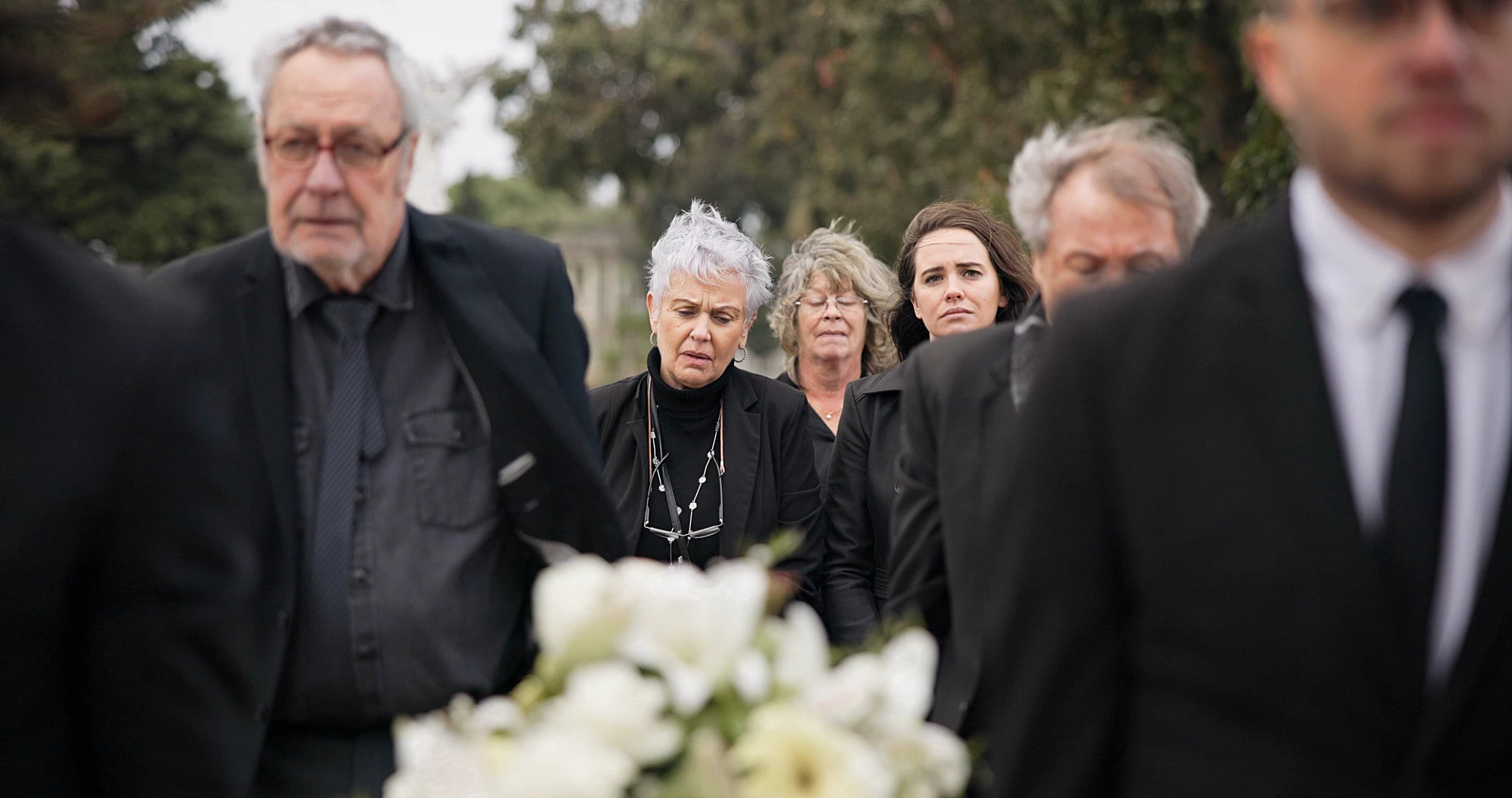 Pallbearers carrying a coffin at a Sydney funeral