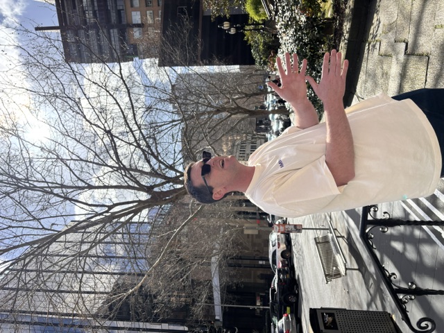Martin gesturing through a CBD side street