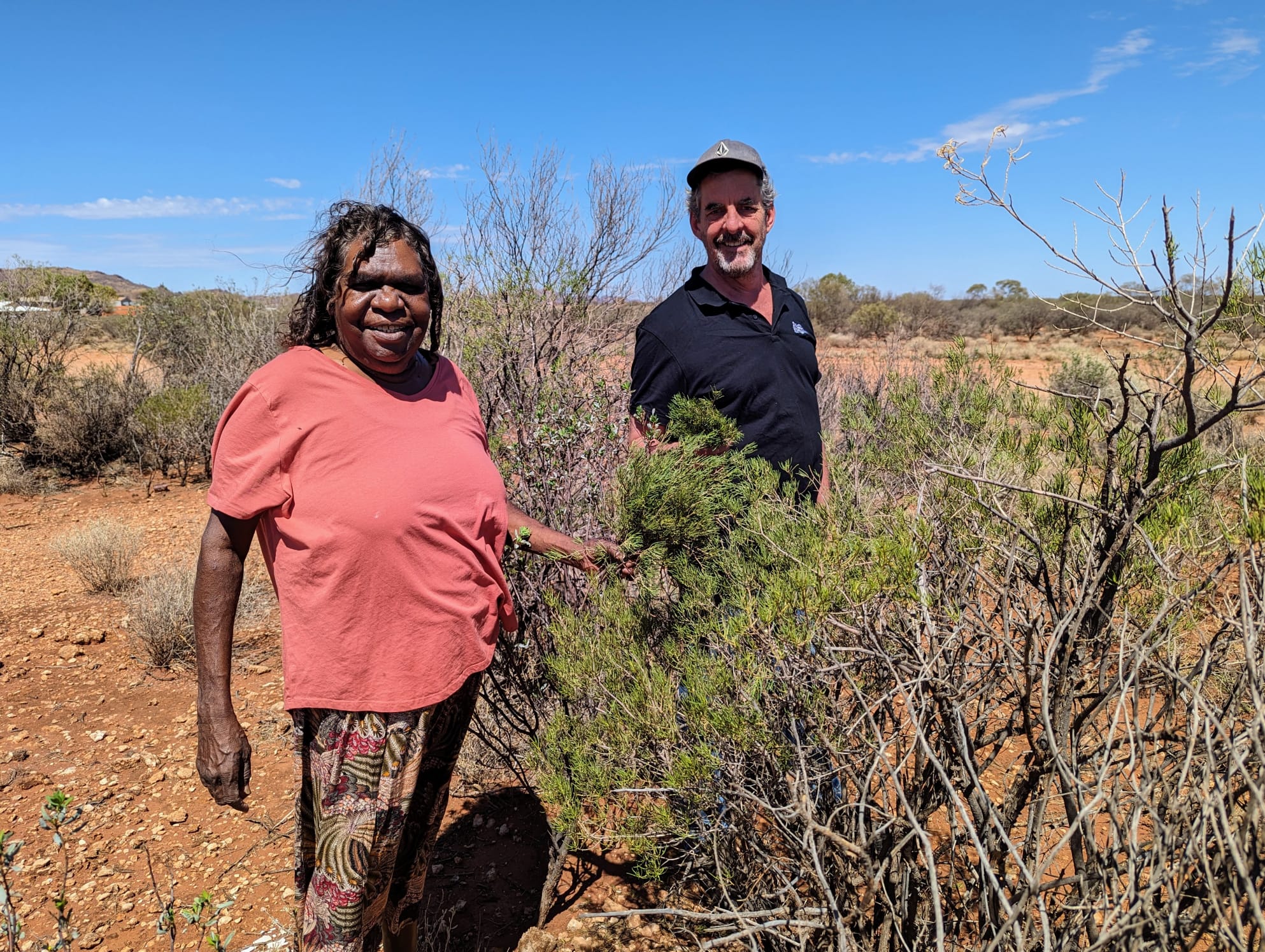 Linda Eddy and William Martin on Country with native shrubs